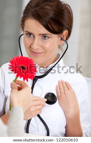 Doctor is shocked recieve flower from patient