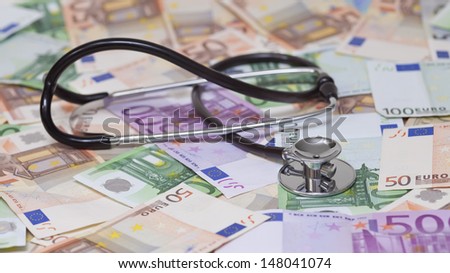 euro banknotes and stethoscope
