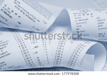 Paper cash register receipts in a lose pile close up