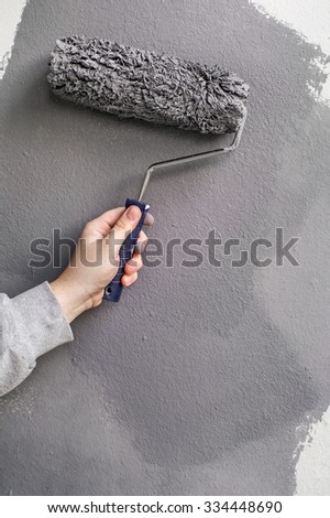 Gypsum wall painting with paint roller - hand applying
