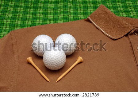Golf balls, and tees on golf shirt
