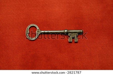 Antique key on red cloth