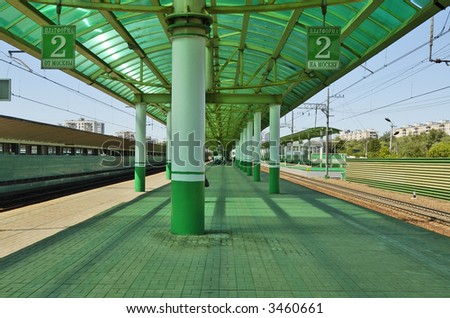 green covered passenger platform at  rail station