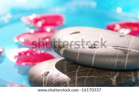 spa stones  closeup on blue water background