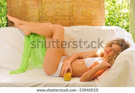 blond girl  resting  on sofa in  hot summer day