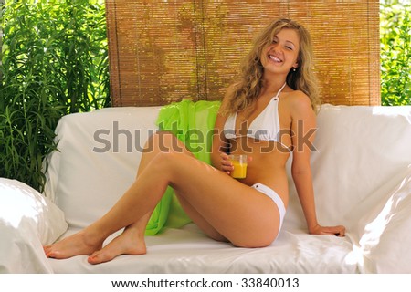 blond girl  resting  on sofa in  hot summer day
