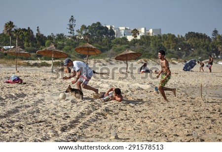 AL HAMMAMAT, TUNISIA, 25 JUN - 2015: Local young men playing football on the beach.