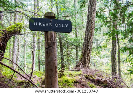 A wooden trail sign keeps hikers from getting lost