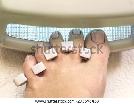 Preparation of a female foot for a pedicure in medical salon