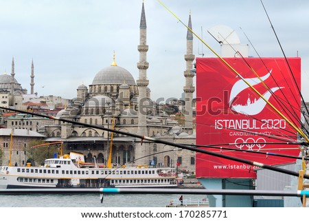 ISTANBUL, TURKEY - APRIL 20: Turkish people fishing on the Galata Bridge with New Mosque and an advert for Istanbuls bid for 2020 Olympics at the background on April 20, 2013, in Istanbul, Turkey.