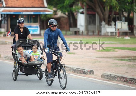 Ayutthaya, Thailand - Aug-6-2014 : Family man, Father go to bike festival in Ayutthaya with 2 sons on Aug 6, 2014 in Ayutthaya