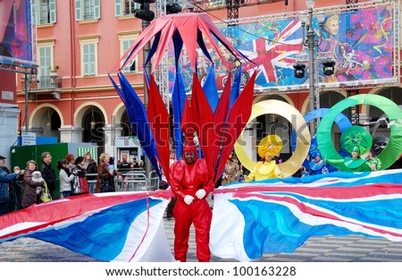NICE, FRANCE - FEBRUARY 21: Carnival of Nice, France. This is the main winter event of the Riviera. Young man dressed in fantastic colorful costume with English flags. Nice, France - Feb 21, 2012