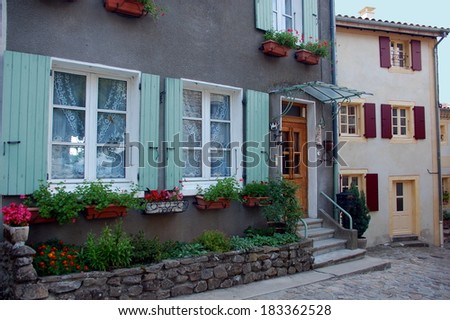Cute flowering doors and windows in houses of Ardeche, France