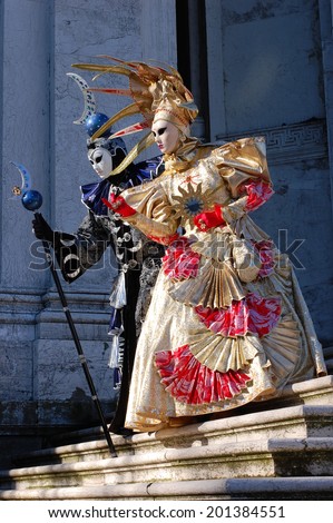 VENICE, ITALY - FEBRUARY 24: The carnival of Venice is held in Italy. Beautiful couple in colorful costumes and masks, Santa Maria della Salute. Wonder and Fantasy Nature. Venice, Italy - Feb 24, 2014