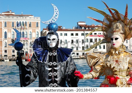 VENICE, ITALY - FEBRUARY 24: The carnival of Venice is held in Italy. Beautiful couple in colorful costumes and masks, view on the Grand Canal. Wonder and Fantasy Nature. Venice, Italy - Feb 24, 2014