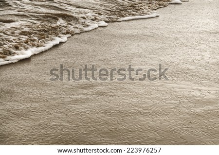Wet sandy beach coastline closeup retro style