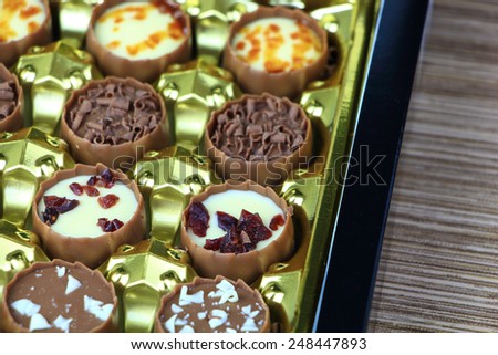 Assorted chocolate confectionery gift box on wood