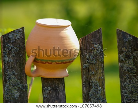 Old broken jars on the wooden fence