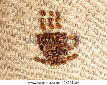 Coffee bean coffecup icon on jute background.