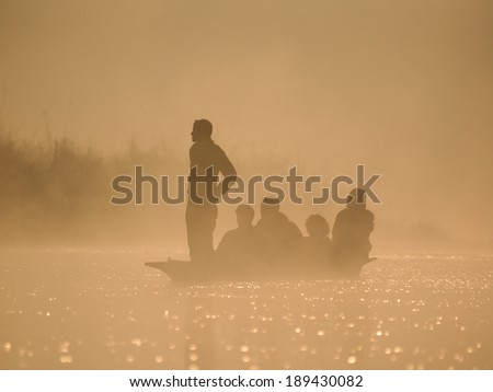 canoes at dawn on a misty morning in Sauraha, Chitwan, Nepal