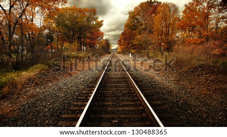 Train tracks running through trees in fall color/Steel Rails Fall