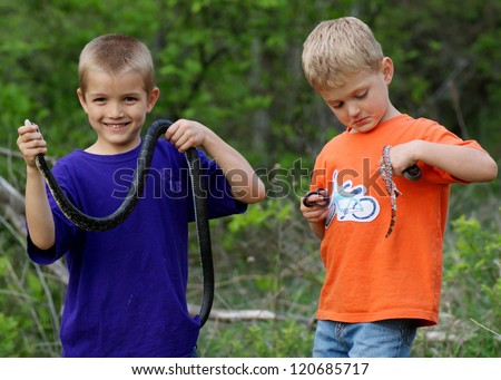 Kids playing outside, catching wild snakes - holding Black Rat Snake, Red Milk Snake, Eastern Yellow-bellied Racer and Western Worm Snake