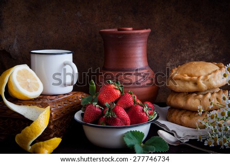 Strawberry, lemon, ceramic jug, pies and daisies in the style of Dutch still life