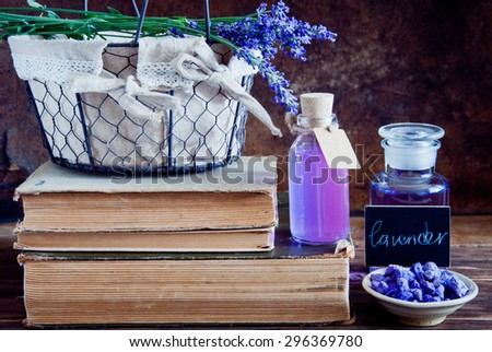 Lavender flowers, lavender essential and old books on a wooden background. Lavender Aromatherapy
