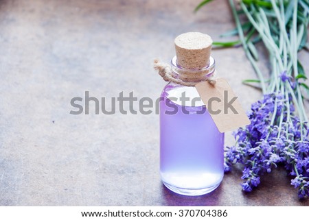 Aromatherapy oil and lavender, lavender spa, Wellness with lavender, lavender syrup on a wooden background