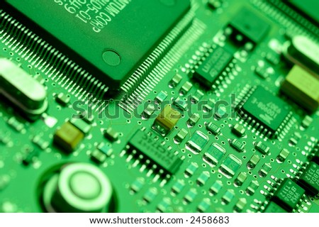 Computer chips on a circuit board with green lighting