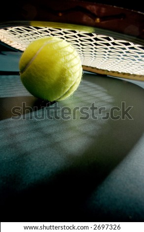 Tennis ball with racket & shadows