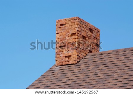 Close up brick chimney on the roof and blue sky