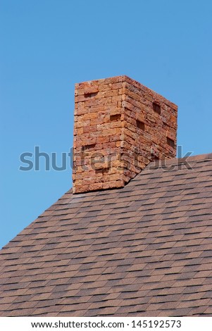 Close up brick chimney on the roof and blue sky