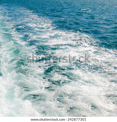 The wake of a boat as seen from the stern of a ship.