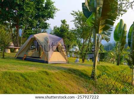 Touristic tent on green grass in a forest resort surrounded by mountains and beautiful gardens at Suanpeung, Ratchaburi, Thailand.