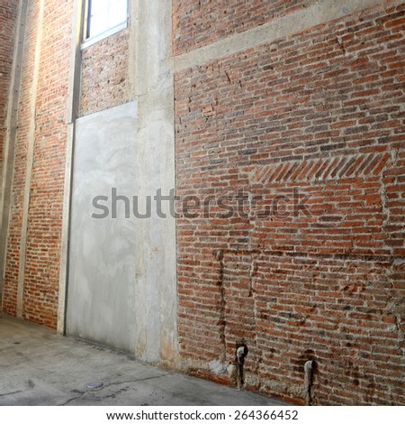 Sunlight from window on the brick walls inside of old building