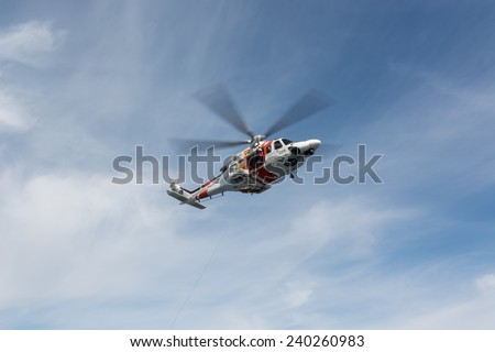 VALENCIA COAST, SPAIN - DECEMBER 25: The helicopter of the Spanish Maritime Rescue Team and his rescuers during rescue exercises, on December 25, 2014 in Valencia coast.