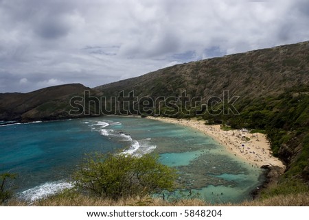 Picture of Hanauma Bay with snorkels and sun bathers on the beach, Oahu, Hi.