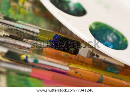 Group of paint brushes and paints.