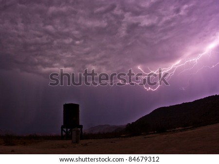 Ominous clouds as lightning creeps toward an abandoned water tower at Dos Cabezas Siding in the Anza-Borrego Desert. San Diego County.