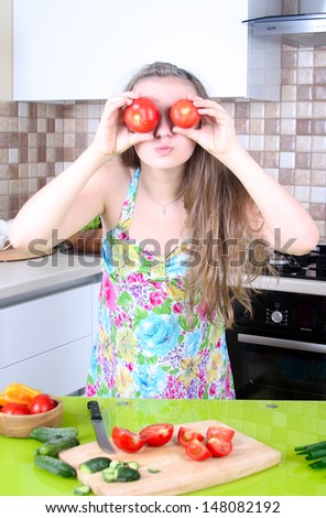 young girl preparing a salad in the kitchen. Healthy food - vegetable salad. Diet. Dieting concept. Healthy lifestyle. Cooking at home. Prepare food