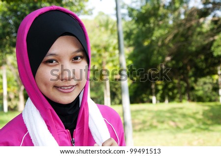 Beautiful muslim women in sport attire in smiling mode.