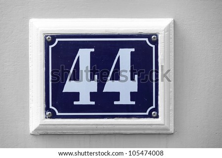 Blue house number tile plaque with floral ornament.