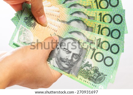woman holding money - AUD - Australian Dollars