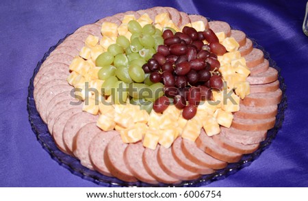 A meat, cheese and fruit tray.