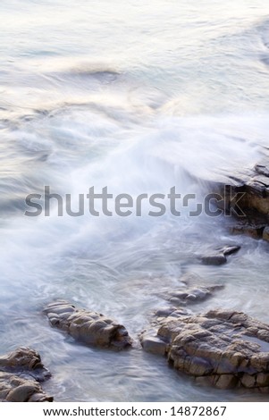 Wave washing on Boiling Pot Rocks, Noosa, Queensland, Australia, using a long exposure to blur water.