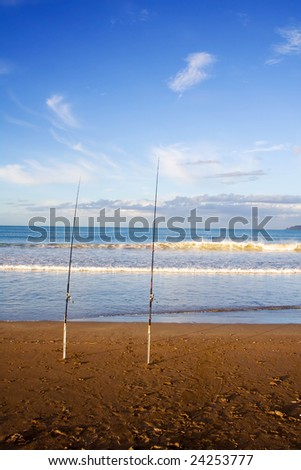 Surfcasting rods in the sand at Taipa Beach on a beautiful summers evening, Northland, New Zealand