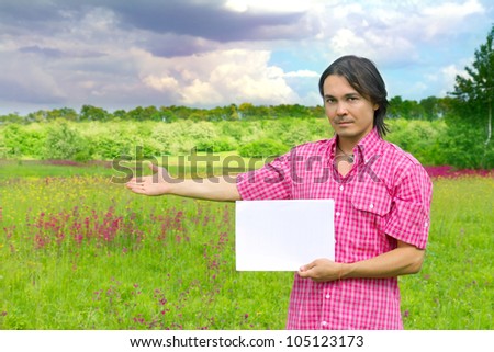 young businessman with blank paper - outdoor environment