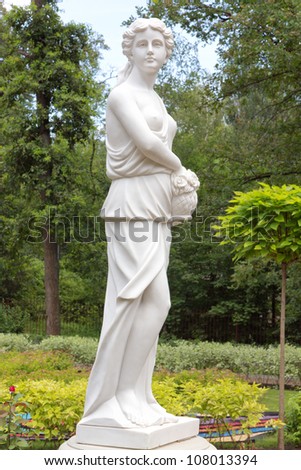 Beautiful statue of young sad woman in the summer park. Bucha, Ukraine