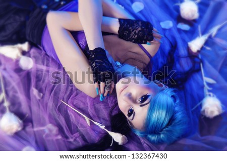 Beautiful gothic woman with blue hairs and white roses